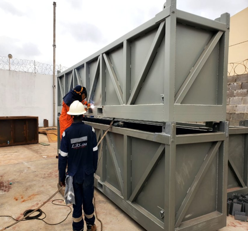 Workers welding large structural steel assembly